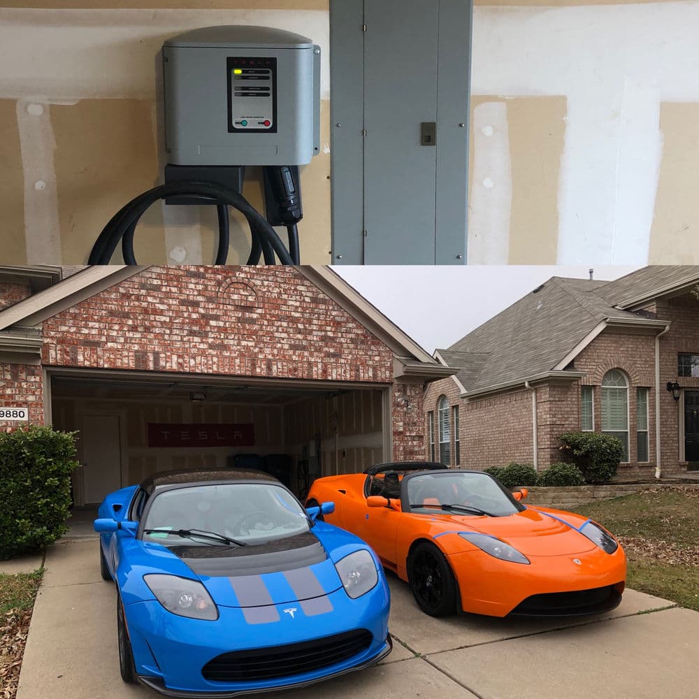 Tesla charging station with blue and orange Teslas parked outside a brick garage.